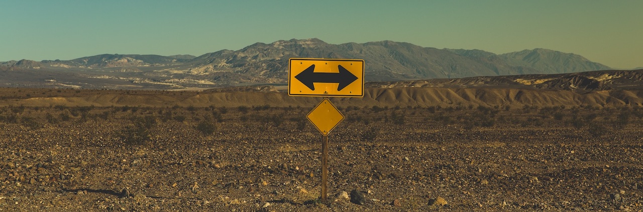 Two way sign in the the middle of a desert